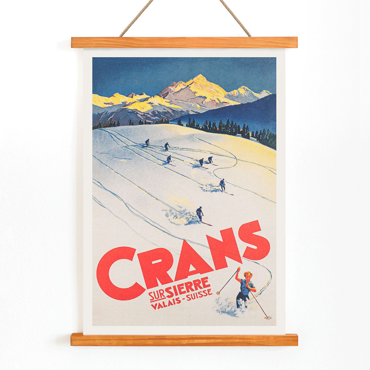 Crans sur Sierre Switzerland Ski Poster by Martin Peikert with skiers descending snowy mountain slopes and vibrant mountain backdrop, with wooden magnetic frame on white background