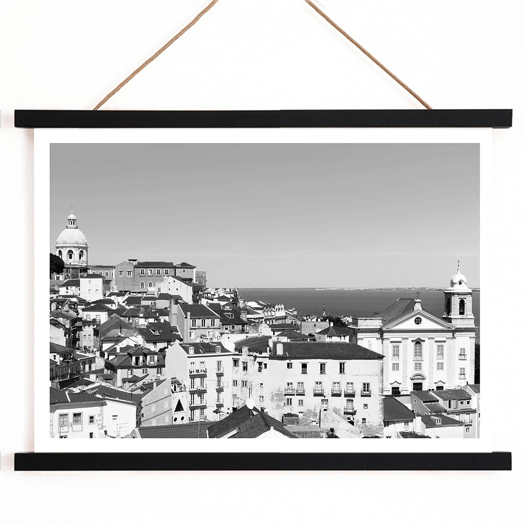 Black and white landscape of Lisbon Old City with historic architecture rooftops and distant sea view poster by Picture 2, with wooden magnetic frame on white background