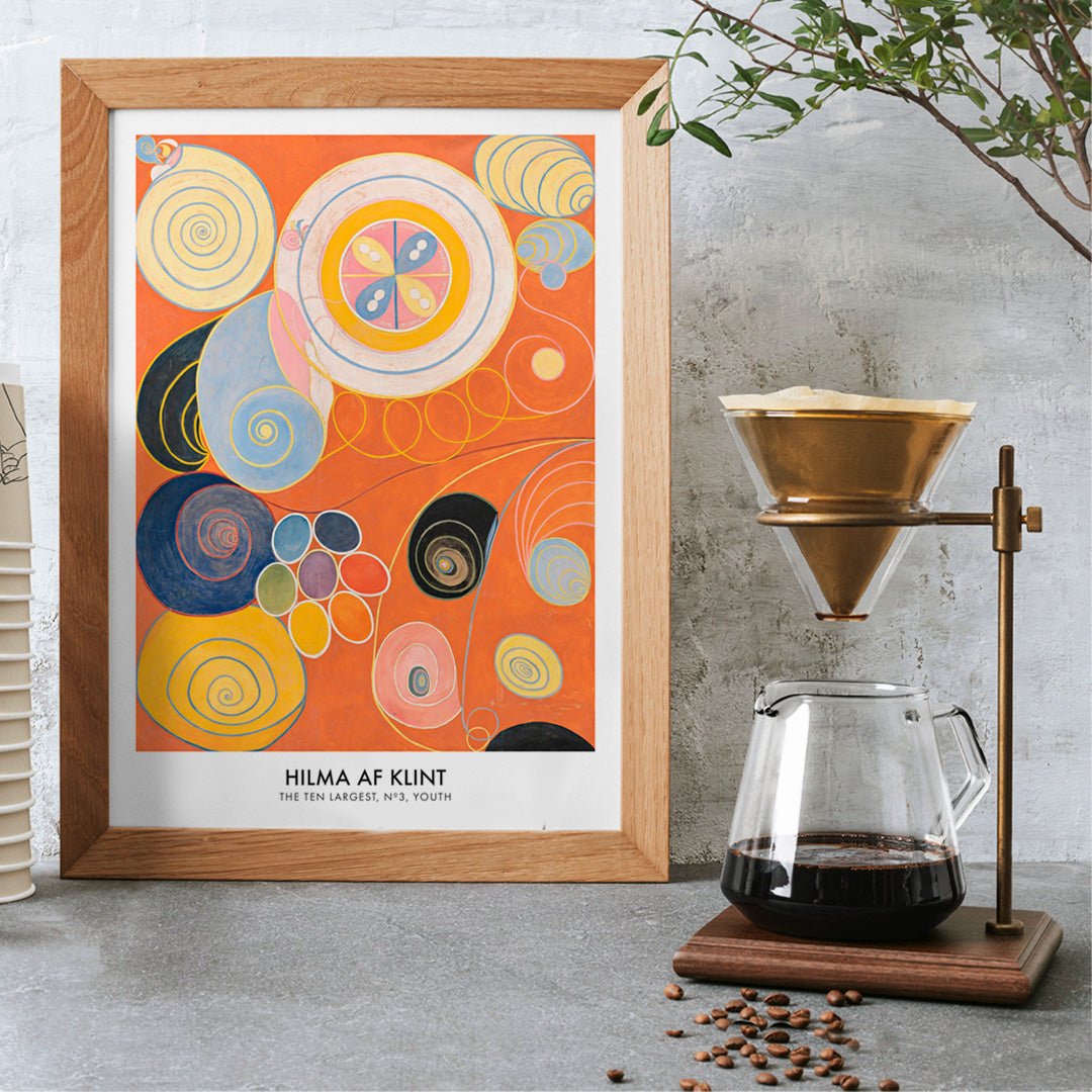 Abstract colorful spirals and organic shapes on vibrant orange background from The Ten Largest Youth by Hilma af Klint, with wooden magnetic frame on white background
