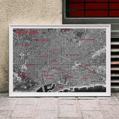 Moryarty Barcelona satellite city map poster in bold black and white aerial style showing city grid districts landmarks monuments and coastline, framed and displayed in modern living room decor