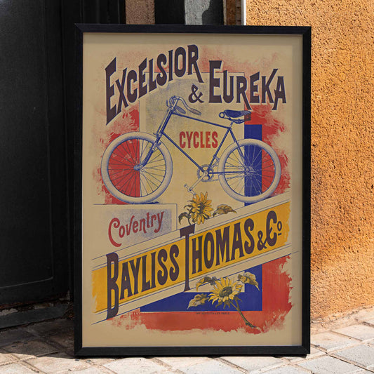 Bayliss Thomas Excelsior and Eureka Cycles vintage poster with blue bicycle and bold lettering, framed and displayed in home decor