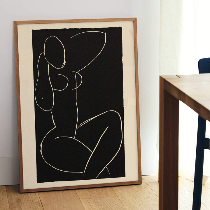 Henri Matisse Seated Nude with Crossed Legs I poster minimalist black and white nude line drawing on dark background, framed and displayed in modern living room decor
