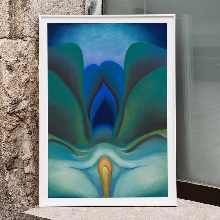 Georgia OKeeffe Blue Flower poster luminous blue and green abstract bloom with soft yellow center, framed and displayed in modern living room decor