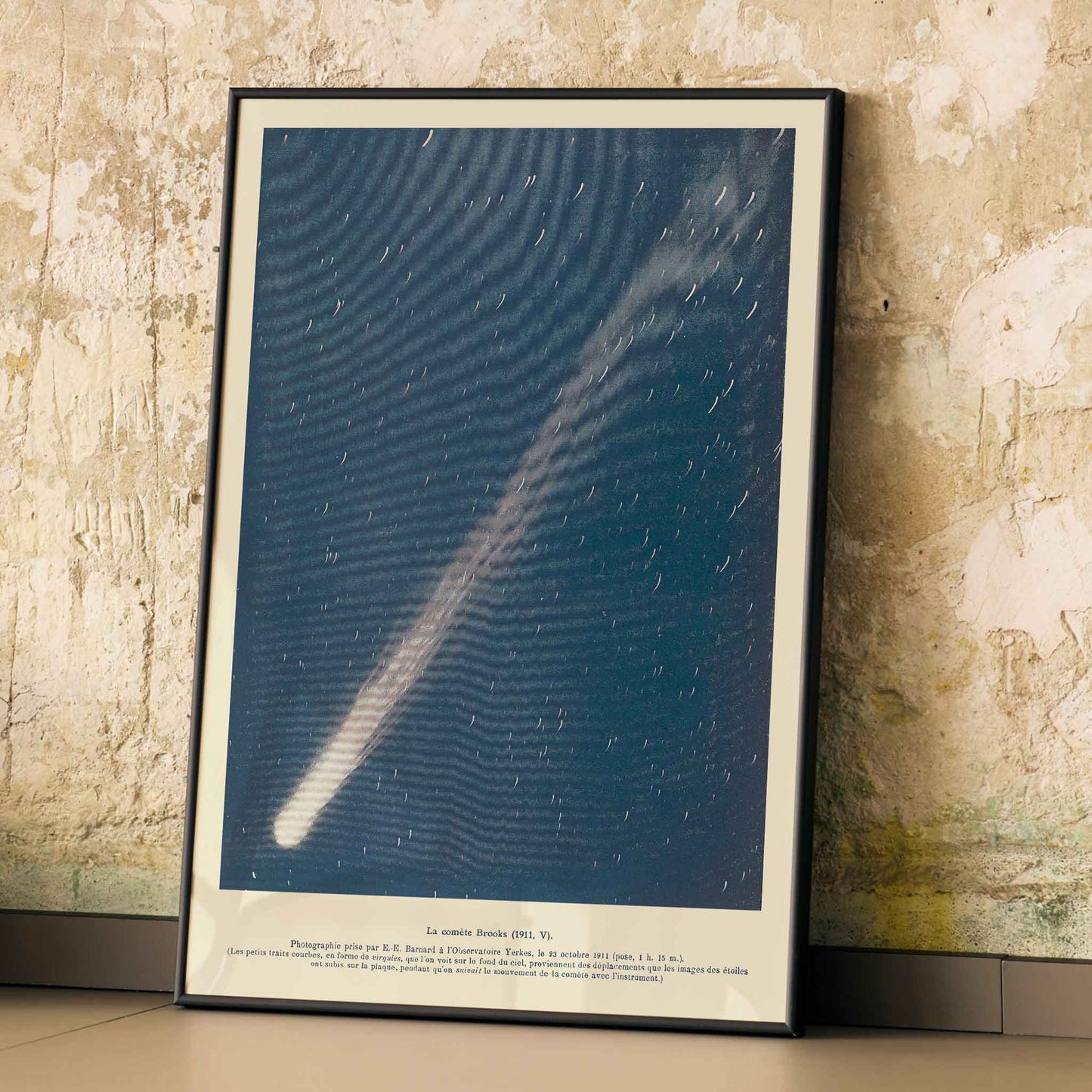 Brooks Comet by Lucien Rudaux poster with glowing white comet crossing a deep blue starry night sky, framed and displayed in modern living room decor