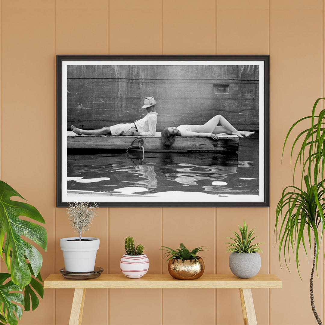 Marquess of Tavistock Henry Robin Ian Russell and Henrietta Tiarks relaxing on a dock in Bermuda by Toni Frissell poster, framed and displayed in home decor
