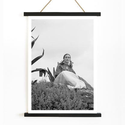 Frida Kahlo and Senora Diego Rivera seated beside agave plant photographed by Toni Frissell poster artwork, with wooden magnetic frame on white background