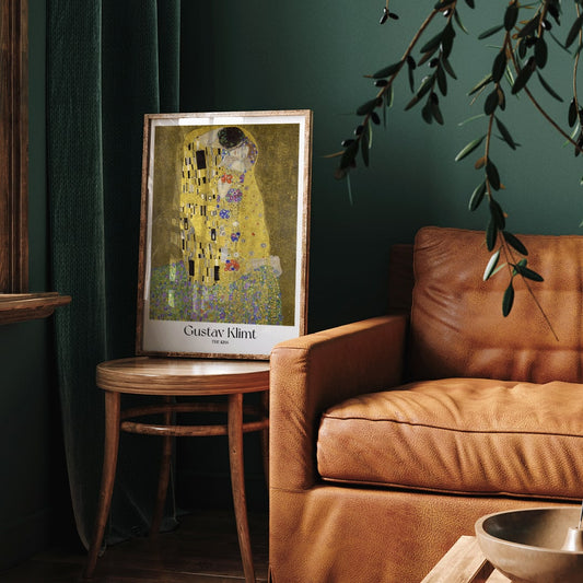 The Kiss by Gustav Klimt featuring two lovers embracing in a richly decorated golden background with floral patterns romantic couple artwork poster, framed and displayed in home decor