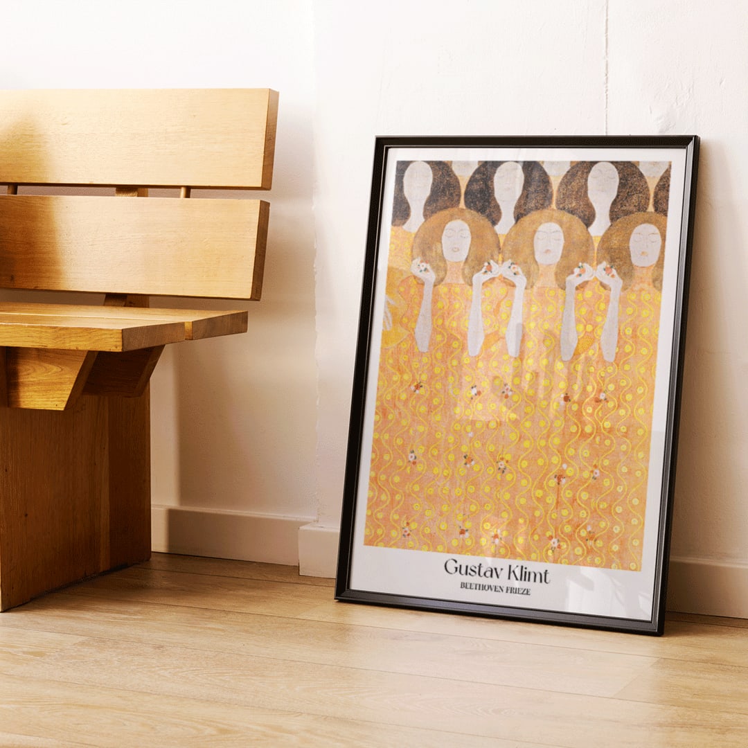 Beethoven Frieze by Gustav Klimt featuring women in flowing yellow gowns with intricate golden and orange patterns and faceless figures, framed and displayed in home decor