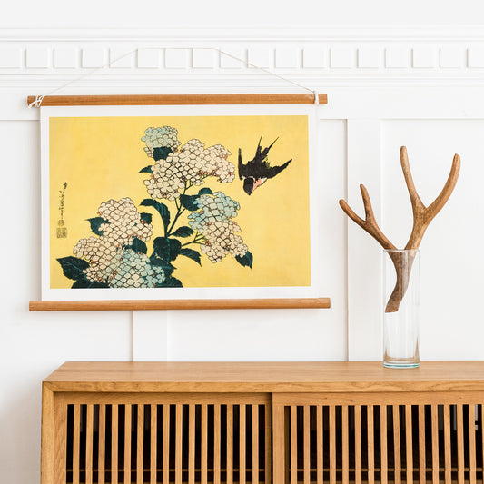 Swallow bird flying near blooming hydrangea flowers artwork by Katsushika Hokusai titled Hydrangea and Swallow on yellow background, framed and displayed in home decor