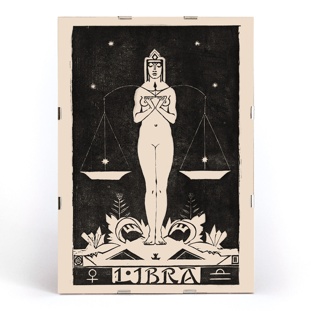 Art Nouveau Libra zodiac sign illustration by Henri van der Stok featuring a woman holding balanced scales and stars, framed and displayed in modern living room decor