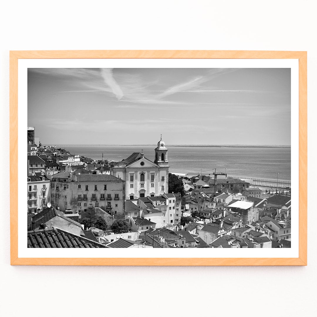Lisbon Old City Landscape Black and White Picture 1 showing historic buildings rooftops and ocean view waterfront poster, framed and displayed in modern living room decor