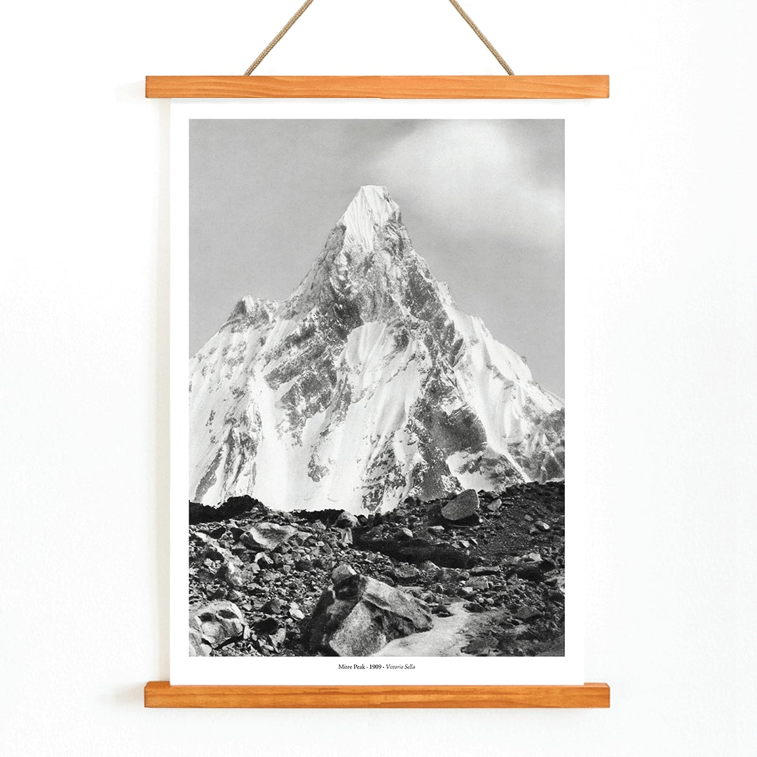 Mitre Peak surrounded by rocky terrain and snowy peak seen from Baltoro Glacier by Vittorio Sella, with wooden magnetic frame on white background