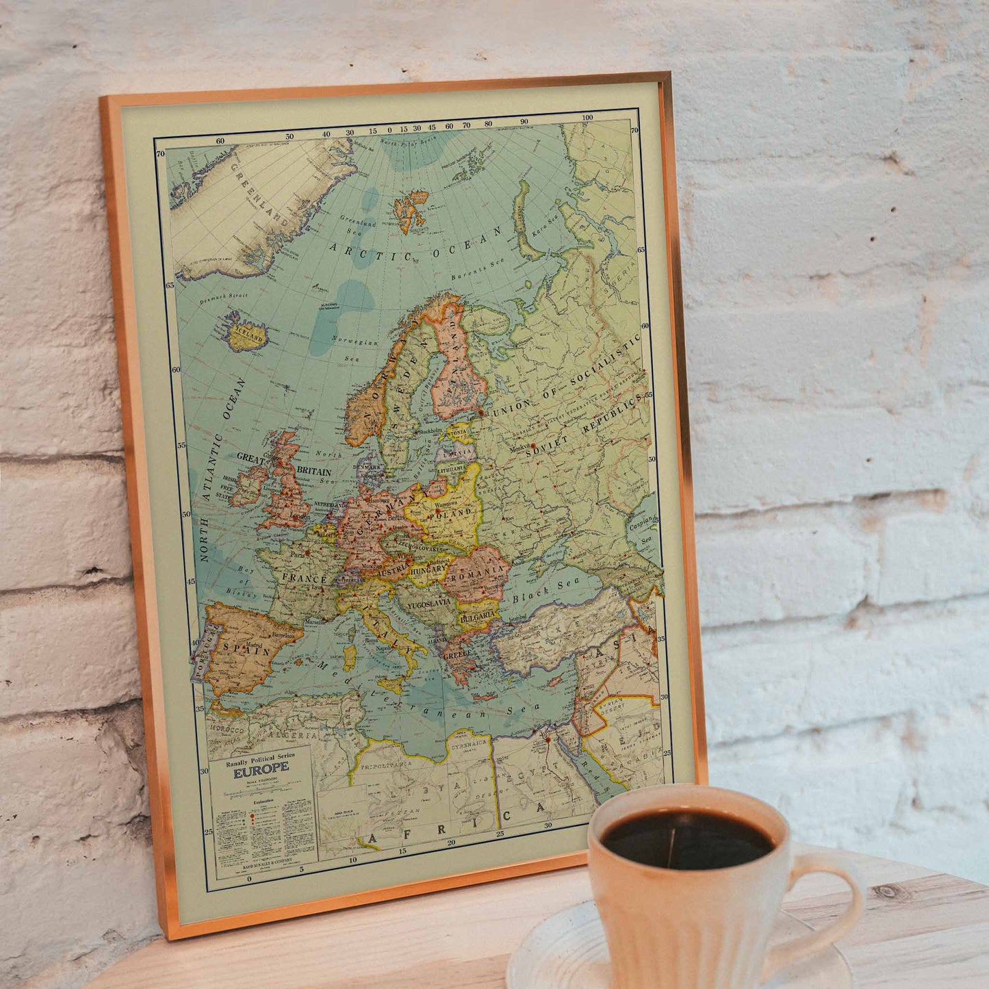 Rand McNally and Company Political Map of Europe poster with detailed continental map, colored borders, seas, and vintage cartographic typography, framed and displayed in modern living room decor
