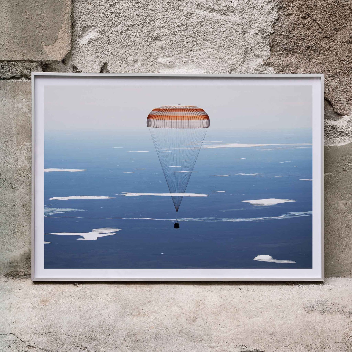 Soyuz MS-02 spacecraft descending with parachute over Kazakhstan NASA poster artwork showing landing, framed and displayed in home decor