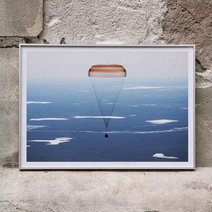 Soyuz MS-02 spacecraft descending with parachute over Kazakhstan NASA poster artwork showing landing, framed and displayed in home decor