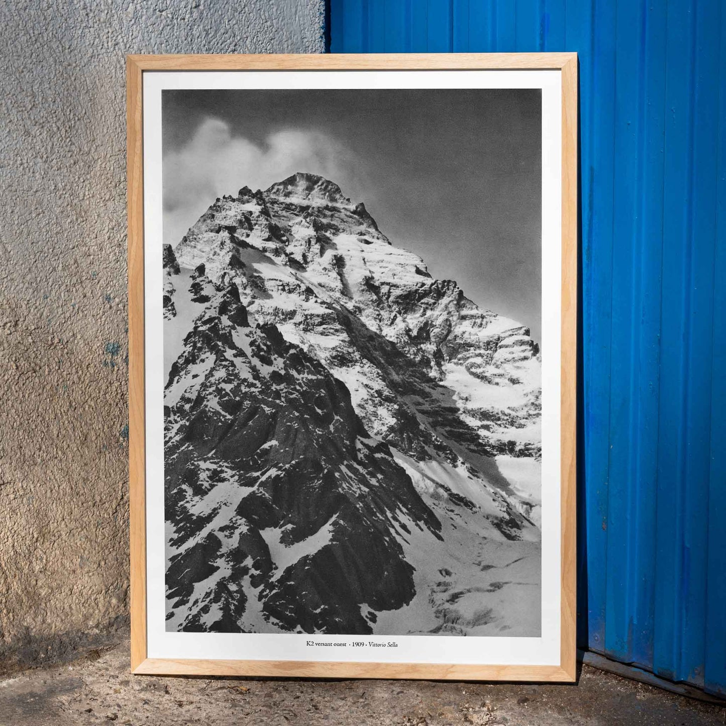 Black and white photograph and poster of K2 west face by Vittorio Sella showing the snow-covered mountain peak, framed and displayed in home decor