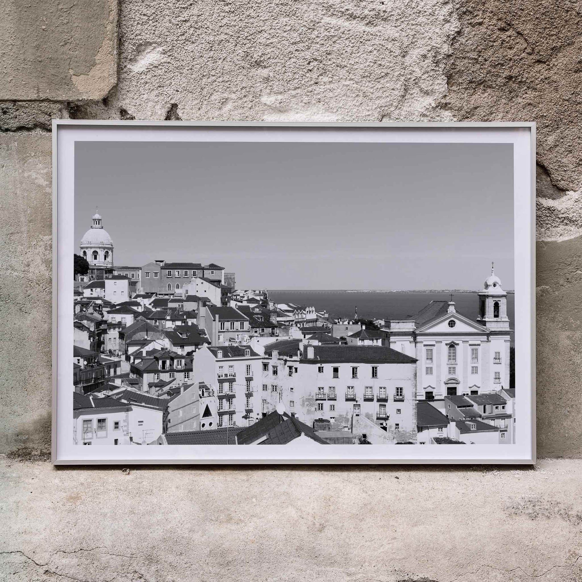 Black and white landscape of Lisbon Old City with historic architecture rooftops and distant sea view poster by Picture 2, framed and displayed in home decor