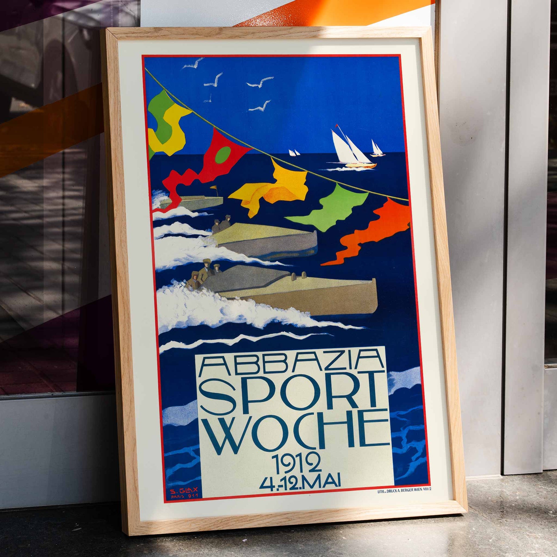 Colorful regatta scene with motorboats and sailboats racing on blue water with colorful flags by Stefanie Glax Abbazia Sport Woche, framed and displayed in home decor