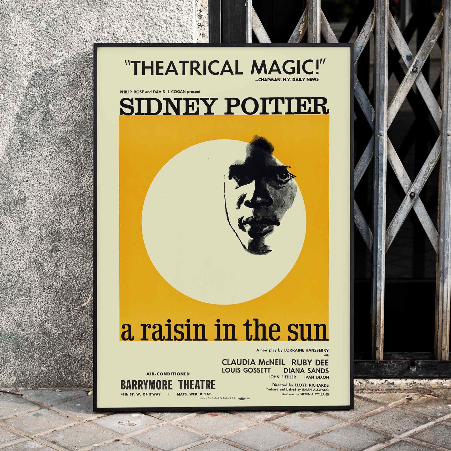 Theatrical poster for A Raisin in the Sun by Artcraft Lithograph featuring Sidney Poitier and a stylized face with text and theatrical information, framed and displayed in home decor