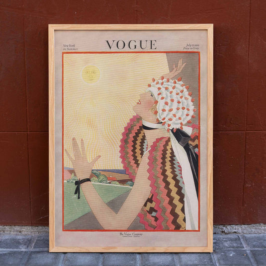 Art Deco Vogue poster of a woman in vibrant attire reaching for the sun by George Plank, framed and displayed in home decor