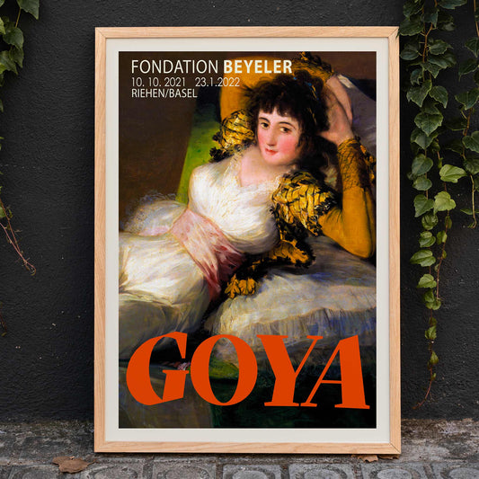 The Clothed Maja exhibition poster by Francisco Goya at Fondation Beyeler showing a reclining woman in a white and gold dress with yellow sleeves, framed and displayed in home decor