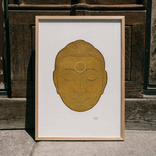 Serene golden Buddha head artwork with closed eyes by Reijer Stolk titled Head of Buddha on white background, framed and displayed in home decor
