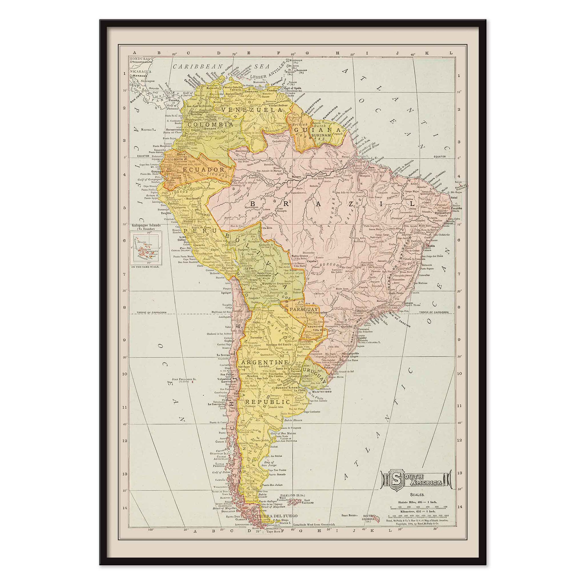Vintage Rand McNally South America map poster with labeled continent in soft yellow pink and beige cartographic detail, with black aluminium frame on white background