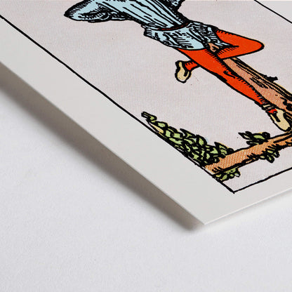 Closeup detail of Hanged Man Tarot Card by Rider Waite, figure hanging upside down from wooden structure, mystical poster art