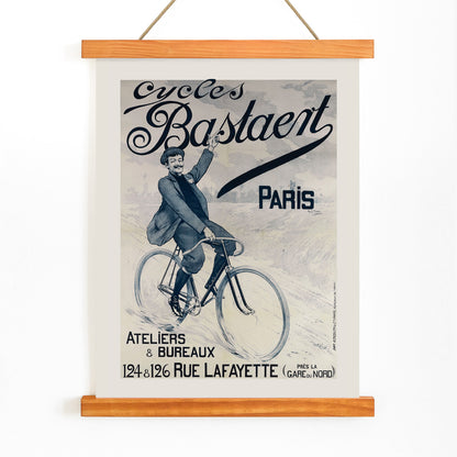 Vintage bicycle poster joyful man riding and waving on Cycles Bastaent Paris bike artwork by Charles Tichon, with wooden magnetic frame on white background