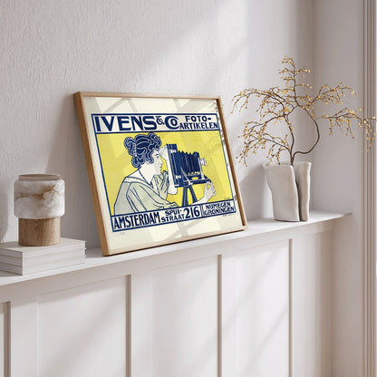 Art nouveau poster of woman using vintage camera at Ivens and Co Camera Shop by Johann Georg van Caspel, framed and displayed in home decor
